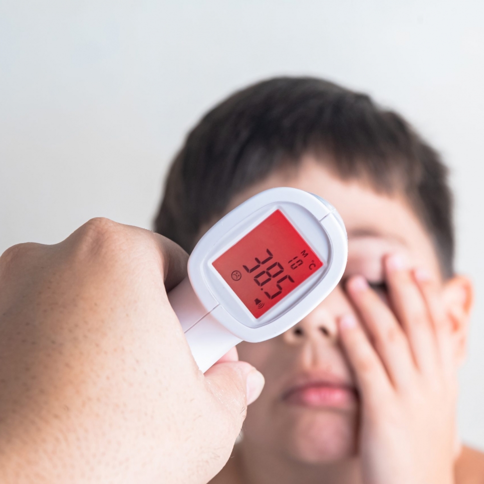 Measuring the fever of a cute boy
